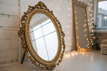 Elegant vintage mirror with ornate gold frame reflecting a cozy, well-lit space