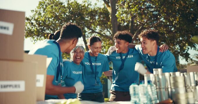 Volunteer, happy people and team in celebration together, jump and donation success. Charity, group and cheers outdoor for support, huddle and community service with food drive for humanitarian aid