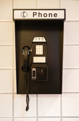 A vintage coin-operated telephone, showcasing retro design and nostalgic appeal, representing the classic telecommunications era with its timeless and iconic aesthetic.