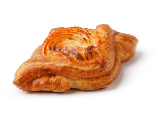 Flaky pastry with swirls sits on a clean surface in a bright kitchen setting during the morning hours
