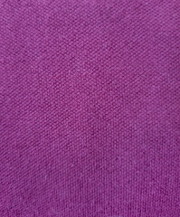 Pink fabric with a prominent texture photographed in close-up suitable for clothing and backgrounds
