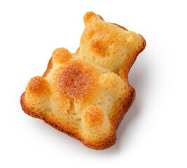 Cute bear-shaped baked good with golden crust displayed on a clean surface in a bright setting