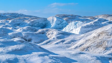 Obraz premium Snow-covered landscape with icy formations under a clear blue sky.