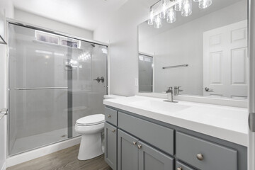 Modern shower room with glass enclosure and sink.