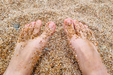 Relaxation and Summer Vibes: Feet Sinking into Sandy Beach