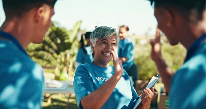 Park, people and happy with high five for volunteering, community service and charity program. Discussion, mature coordinator and team with clipboard for donation, ngo project and support for goal