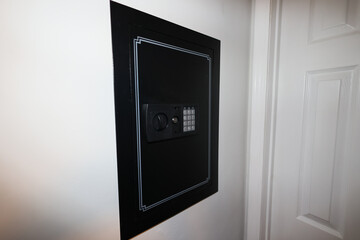 A close-up of a hidden in-wall safe discreetly installed within a wall. The sleek design emphasizes security and practicality for safeguarding valuables.