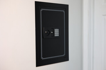 A close-up of a hidden in-wall safe discreetly installed within a wall. The sleek design emphasizes security and practicality for safeguarding valuables.