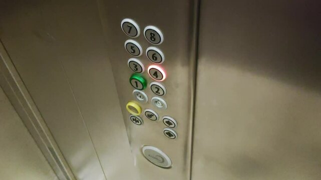 Hand pressing floor button in elevator, close-up. Service lift