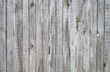 A wooden fence with a lot of holes in it