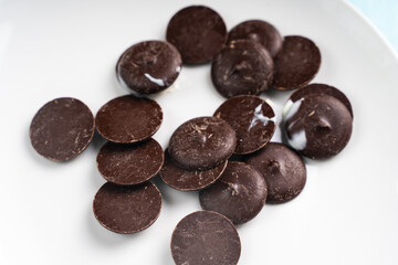 Professional chocolate in biscuits or Chocolate drops for tempering and making sweets