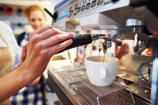 Close-up of barista making coffee at a cafe - Powered by Adobe