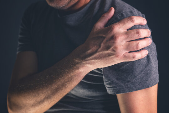 Aching frozen shoulder pain as symptom of rotator cuff tendinitis, adult caucasian male suffering from chronic bursitis