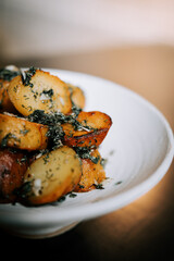 Fried Potatoes With Herbs Served in a Rustic White Bowl for a Comforting and Delicious Meal Experience