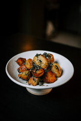Fried Potatoes With Fresh Herbs Served on a White Ceramic Plate, Showcasing a Delicious and Appetizing Dish Perfect for Any Meal Setting
