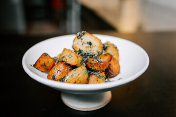 Fried Potatoes With Herbs Served on a White Plate for a Delicious Side Dish