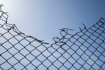 Broken wire mesh fence