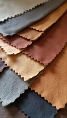 Fototapeta premium A collection of genuine pigskin leather samples showcases a variety of colors, including shades of orange, gold, brown, and black. Each piece displays unique textures and finishes. Generative AI