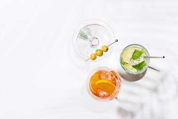 A vibrant display of cocktails, including Aperol Spritz, Mojito, and Martini