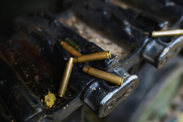 Spent Bullet Casings on Rusty Industrial Machinery Showing Urban Decay