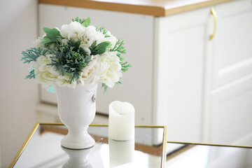 Elegant Floral Arrangement and Candle on Modern Mirrored Table in Bright Kitchen