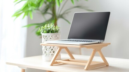 Computer home laptop ergonomic concept. Bright ergonomic desk, laptop on a tilt stand, light and airy design with supportive office furniture for a healthier workflow