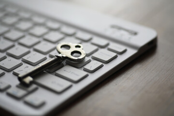 Old Fashioned Key Lying on Modern Computer Keyboard Symbolizing Digital Security