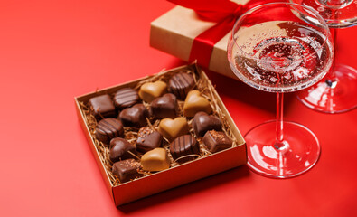A glasses of champagne elegantly paired with a box of rich chocolates