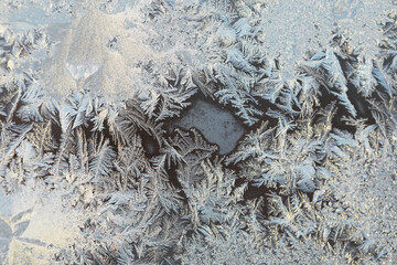 Close-Up of Frost Patterns on Glass Surface in Winter