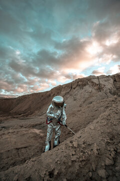 Spaceman on a nameless planet, probing soil
