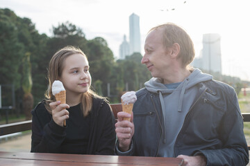 Fototapeta premium Happy family, outdoors portrait. Father and daughter day