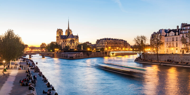 France, Paris, Tourist boat on Seine river with Notre Dame cathedral in background