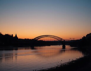 Obraz premium Silhouette of an arched bridge over a river at twilight