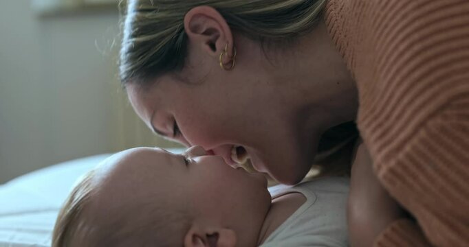 Super slow motion of happy smiling mother and newborn baby son having fun to play together with mother in nursery in morning. Parenthood, childcare, life, maternity, motherhood