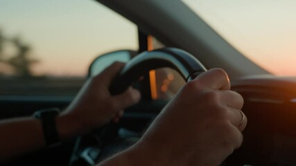 Male driver driving car, inside view. Man driving car on highway road at sunrise. Close-up of driver hands turning steering wheel - Powered by Adobe
