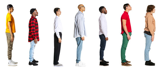 Side view of young men in different casual style clothes standing in front of each isolated on transparent background. Banner. Concept of lifestyle, fashion, diversity, human rights