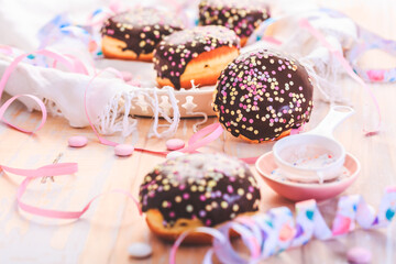 Stuffed Berliner, German donuts for party, carnival, birthday party with streamers