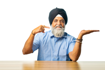 Senior Sikh man sitting at table with white background, expressing various emotions and gestures