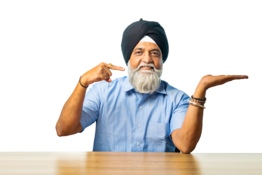 Senior Sikh man sitting at table with white background, expressing various emotions and gestures