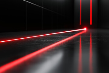 A powerful red laser beam scanning a sleek, glossy black surface. The laser leaves a glowing red trail as it moves horizontally across the surface.  