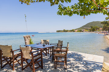 Beachfront Dining Area With Stunning Coastal View And Comfortable Seating