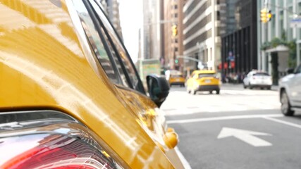 New York City. Yellow taxi car on Manhattan street. Taxi cab on Midtown Lexington avenue. Medallion taxicab rear view on Lex ave waiting for people or passengers on road. Urban scene in United States.