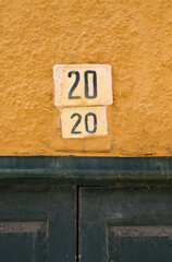 Painted Number 20 on Ceramic Address Plaques on Wall above Old Door