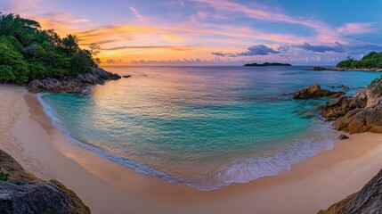 Serene sunrise over a tropical beach with turquoise water, white sand, and rocky shores.