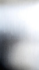 A metallic surface with brushed textures, catching subtle reflections in a minimalist design.
