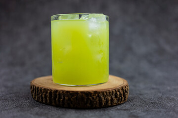 Fresh green guava juice with ice cube in mini glass. Refreshing drink