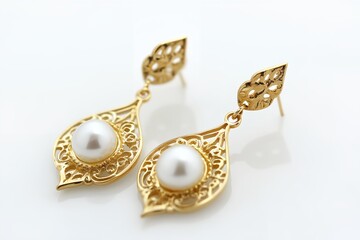 The earrings are made of gold and have a pearl in the center