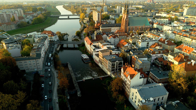 Cityscape of Odra river, bridges, old town, church with two towers in city Opole Poland from drone