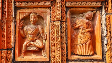 Terracotta carvings depicting men and women in traditional scenes on Lakshmi Janardan Temple,...