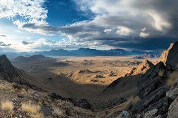 A panoramic view of a vast mountain range, with layers of peaks fading into the distance under a dramatic sky.